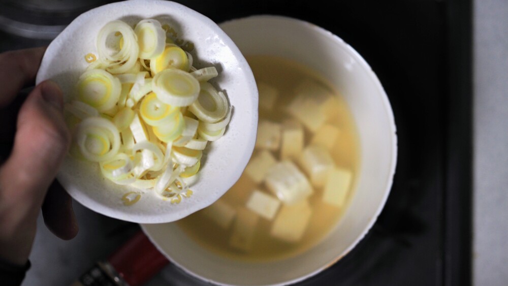 If you would like to cook green onions over heat, add them in this time.