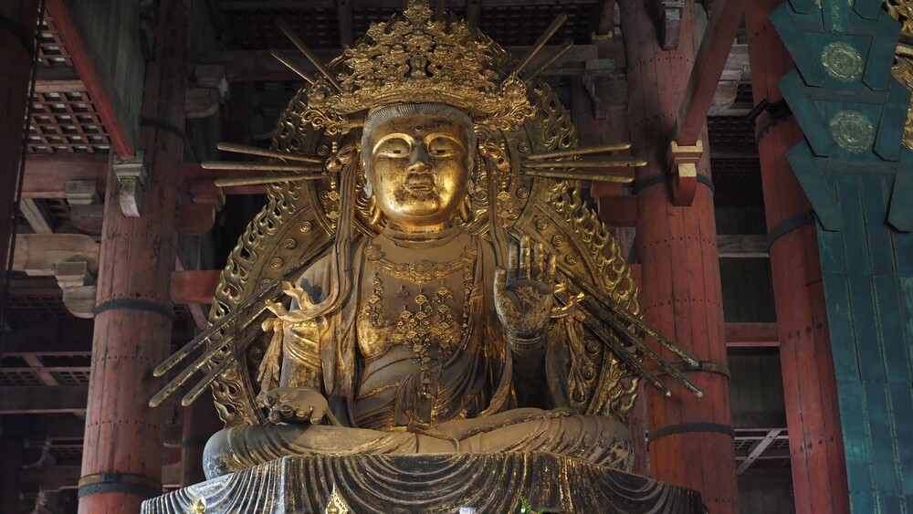 A golden Buddha can be seen in the temple