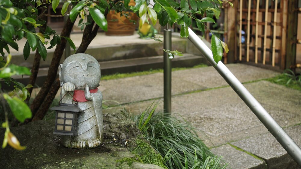 A little Buddha "Ojizo-san" is standing with distinctive lantern